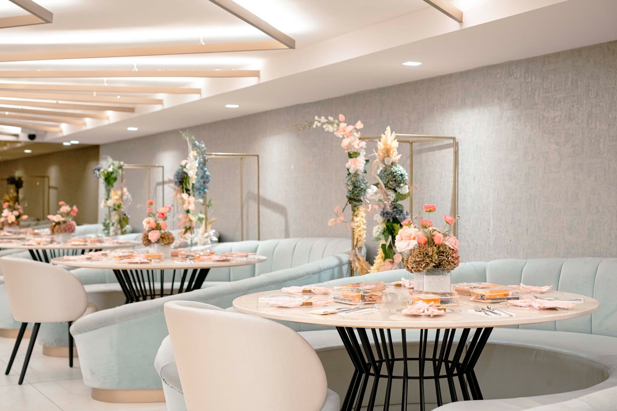 A private dining room dressed with flowers and blush table settings
